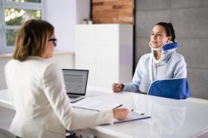 San Diego woman in neck brace and arm sling talks to personal injury lawyer