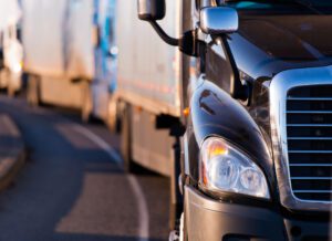 A line of trucks on the road. Discuss your legal situation with a Riverside I-215 truck accident lawyer.