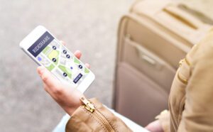 Woman looking at a rideshare app on her phone. A Beverly Hills car accident lawyer can guide you through the legal process and may make your financial recovery easier after a rideshare accident.