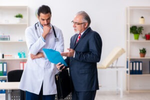A Santa Ana catastrophic injury lawyer meets with the doctor of a client in the hospital.
