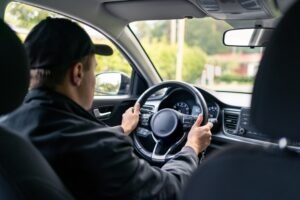 A man working as a rideshare driver. You can seek compensation with a Santa Ana rideshare accident lawyer.