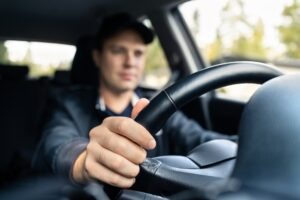 An Uber driver behind the wheel. You can take charge with a Santa Ana Uber accident lawyer after a collision.