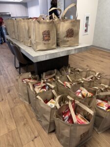 Omega Law Group and PATH volunteers are working hard on the meal kits.