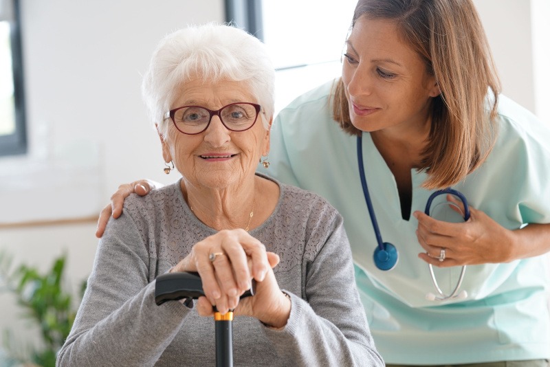 Nurse visiting old woman at home