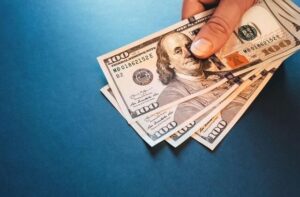 A block that says ‘overtime pay’ on a stack of money. A lawyer can explain overtime pay during federal holidays in Los Angeles.