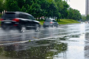 Cars driving in the rain have drivers wondering how to stay safe on wet roads, potholes & sun glare